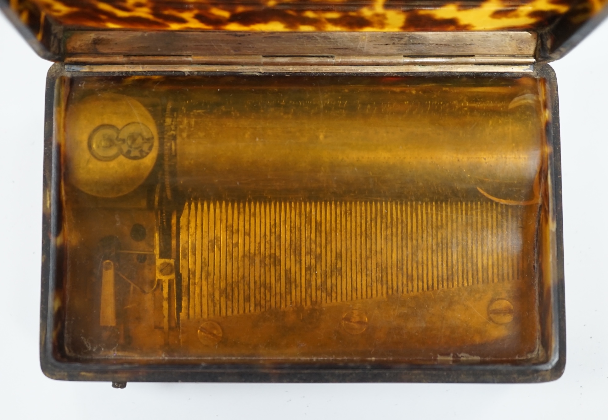 A 19th century tortoiseshell cased musical snuff box, 10cm. Condition - fair